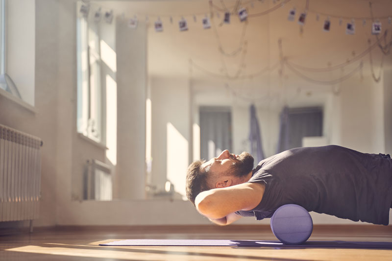 Man on foam roller engaged in Integrative Physical Therapy at Loo Movement